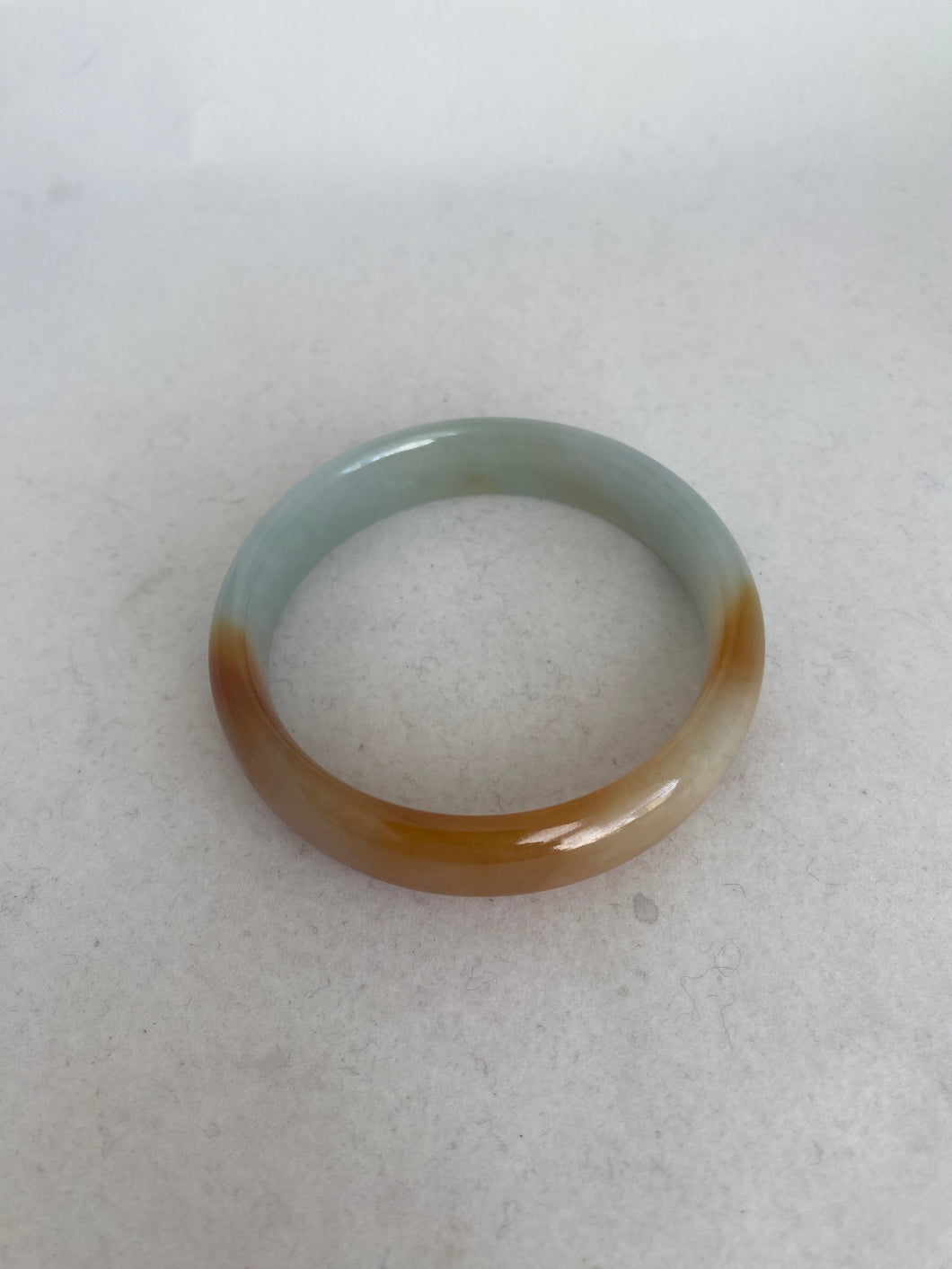 TRANSLUCENT LIGHT GREEN WITH BUTTERSCOTCH JADEITE JADE BANGLE