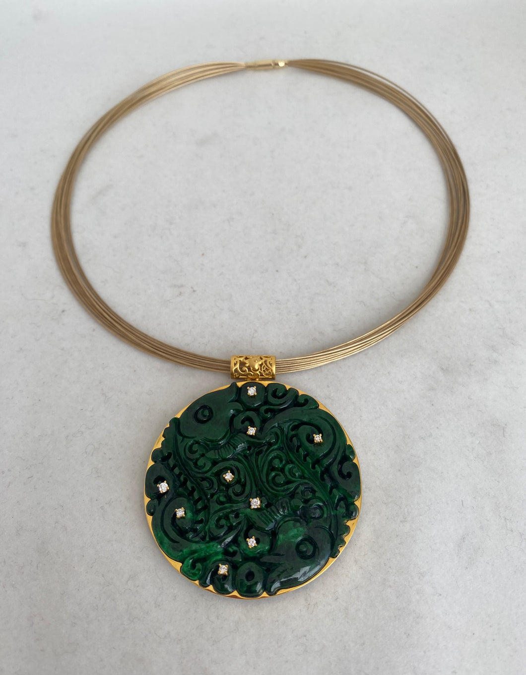 18 KARAT DARK GREEN CARVED FISH JADE PENDANT