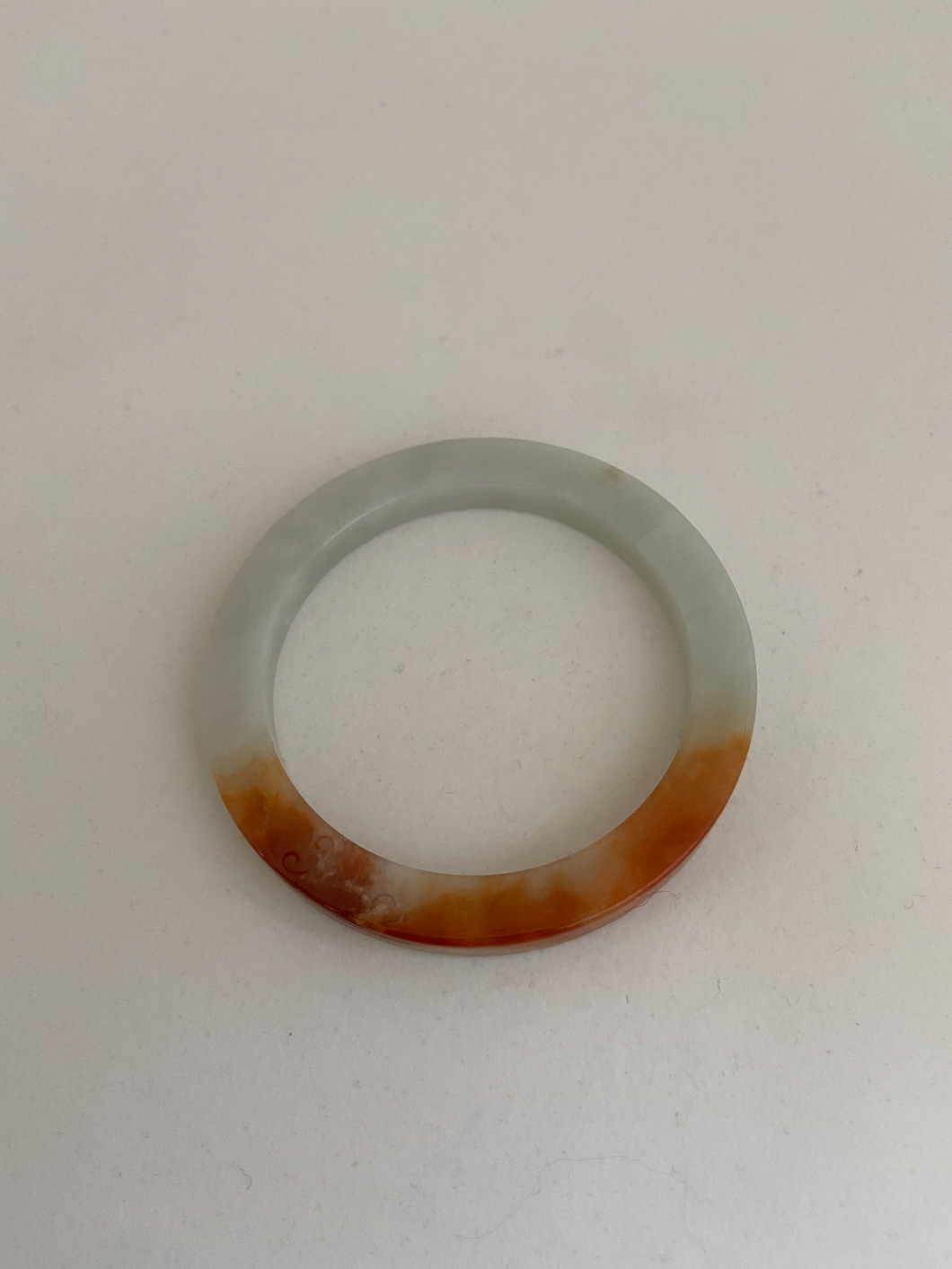 SLIGHTLY CARVED RED JADE BANGLE