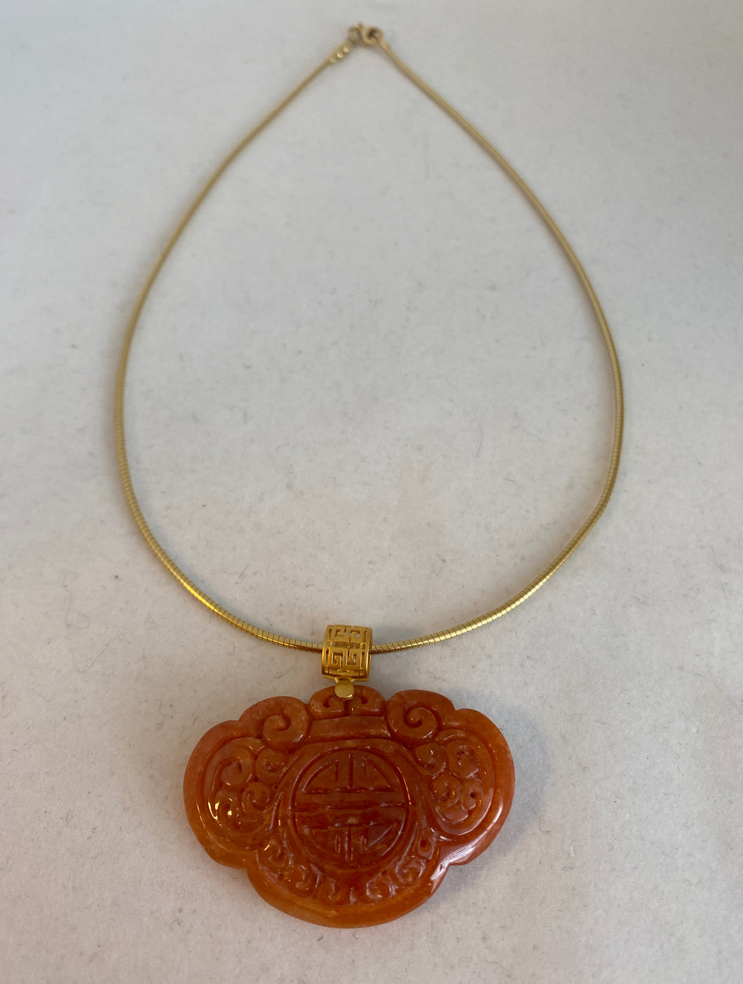 CARVED RED/APRICOT JADEITE JADE PENDANT