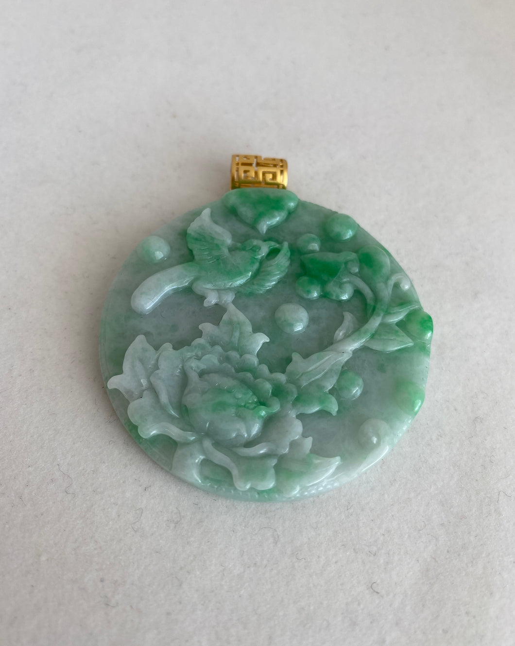 18K APPLE GREEN JADEITE JADE PENDANT WITH CARVED LOTUS AND BIRD OF HAPPINESS