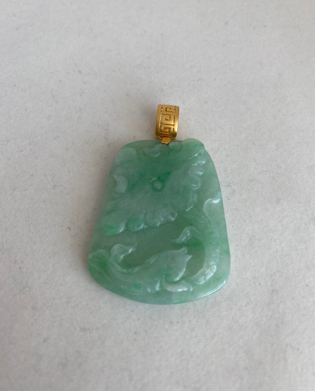 18K TRANSLUCENT APPLE GREEN JADEITE JADE PENDANT DEPICTING LOTUS AND FISH.